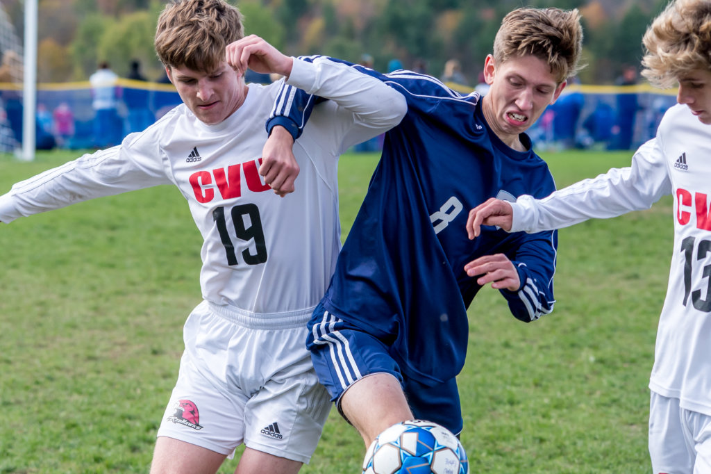 On June 8, Gatorade announced CVU’s Cullen Swett as Vermont’s Gatorade soccer player of the year for the 2019-20 season. The award is based on athletic excellence, academic achievement and exemplary character demonstrated on and off the field. Swett has been recruited to play at the University of Vermont in the fall. Show in photo is CVU’s Cullen Swett (19) tussles with a Cougar. Photo by Al Frey