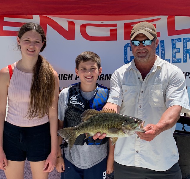Malayna, Myles, and Mike Solomon of Charlotte show off the smallmouth bass they caught over Father’s Day weekend at the LCI Fishing Derby. Photo by Bradley Carleton