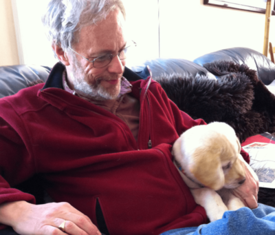 The crux of Philip Fass’s work is sharing personal histories. Here, he sits with pup Etta. Courtesy photo
