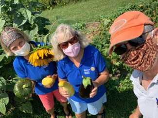 Susan Grimes (Shelburne), Linda Gilbert (Charlotte), and Chris Davis (Charlotte) socially distance in the garden.
