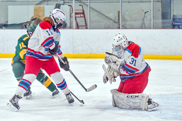 Women’s hockey Redhawk goalie Grace Ferguson makes the save. Photo by Al Frey