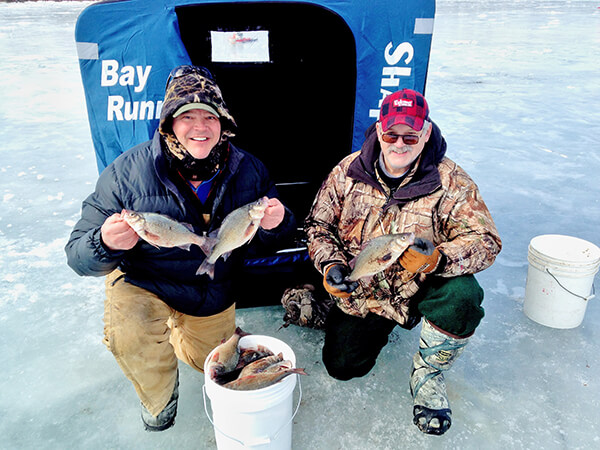 Bradley Carleton and his fishing partner, Steve Osborne of Williston, at St. Albans Bay with buckets of white perch. Courtesy photo