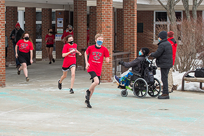 Athletes and a partner in Special Olympics run.Photo by Al Frey