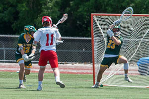 CVU's Shame Gorman cuts into the Bulldog lead during the Boys D1 Lacrosse Final between the Bulldogs and Redhawks at BHS on Saturday. Photo by Al Frey