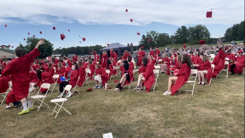 Graduates throw up their caps. Photo by Nick Bishop