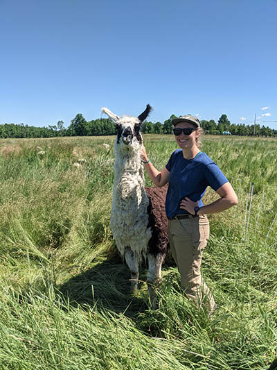 Odyssey takes a neck-scratching break from sheepherding with Philo Ridge Farm livestock manager Isabelle Lourie-Wisbaum. See full story on page 8. Photo by Matt Zucker