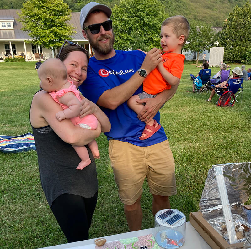 Left: Charlotte Energy Committee member Jacqui DeMent with her newborn, husband and son, who’s happily licking the solar-melted chocolate off his face. Jacqui joined the committee during the pandemic, so this was the first time the committee had met her in person. 