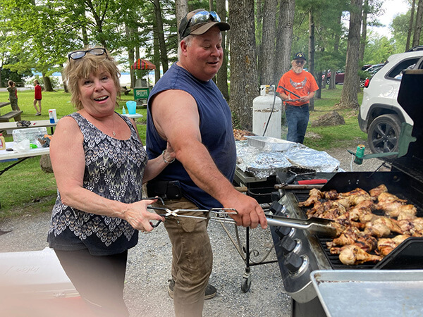 Vanessa Knowles and her husband, Dale, man the barbecue at the party. Dale is Charlotte’s animal control officer.