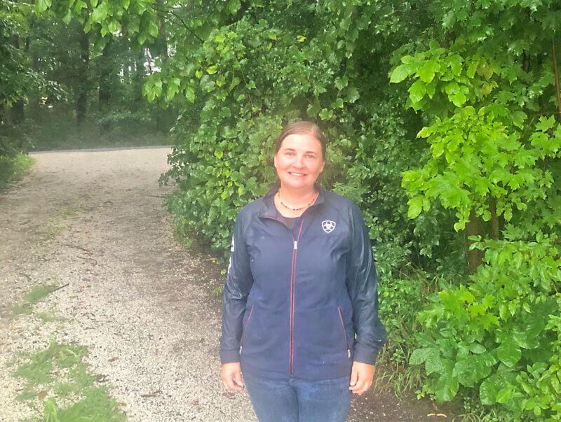 Sarah Thompson stands in the driveway of her property at 2333 Spear Street. Photo by Mara Brooks