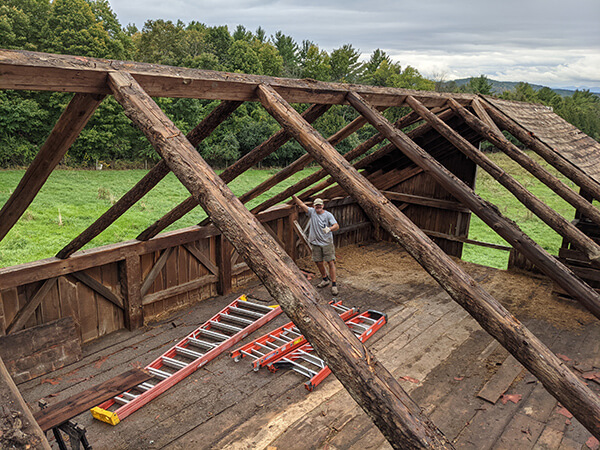 Pete standing in roofless barn.