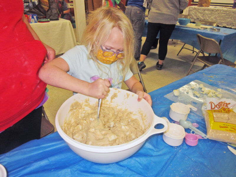 Eve Jagger mixes up the batter for Apple Pie Muffins. Photo by Cindy Bradley