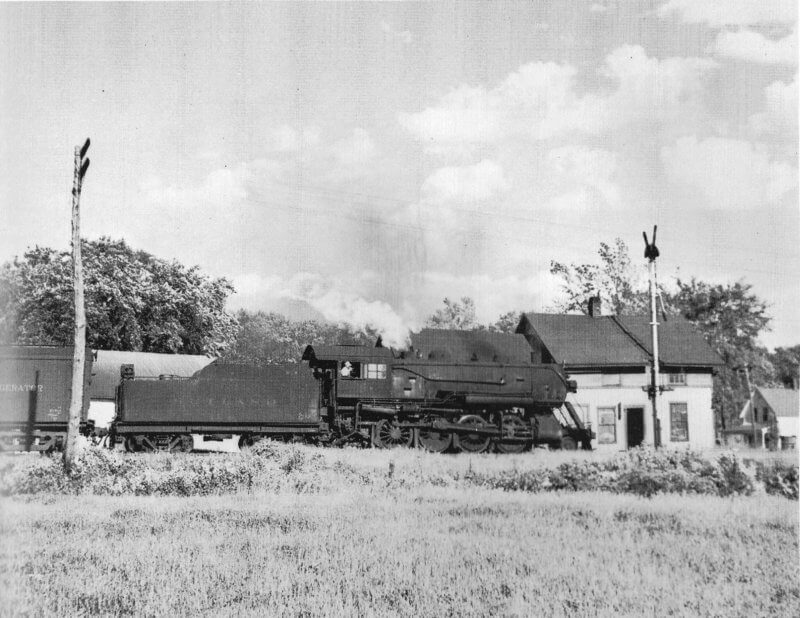 The Consolidation #14 (a 2-8-0 engine) hauling the local freight past the Charlotte depot in the early 1940s. The house on the far right is still standing. From The Rutland Road, by Jim Shaughnessy; photographer, Philip Hastings.