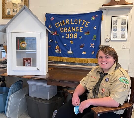 Stuart Robinson pictured with his “little free library” after presenting it to the Grange. In the spring the library will be installed outside and opened for business. Photo by Mike Walker