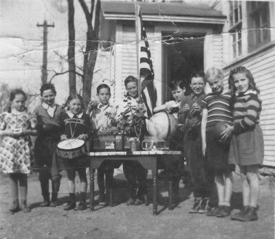 (Left to right) Mary Whalley; William “Bid” Spear; Alice L. Lewis (with drum); unidentified person, unidentified person; unidentified person; Hugh “Cowboy” Lewis; Shirley Whalley; unidentified person. Photo courtesy Susan Horsford.