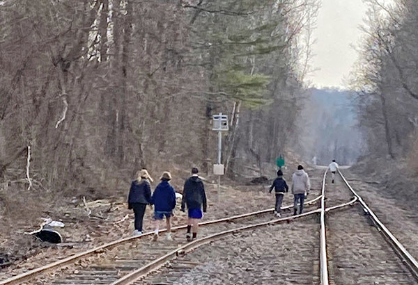 Photo courtesy of Vermont Rail Systems. Six children walk the train tracks near the Shelburne Community School — a sight that concerns school and Amtrak officials.