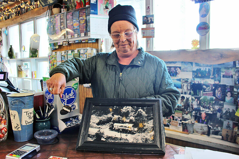 Carrie Spear shows an old photo of Spear’s Corner Store