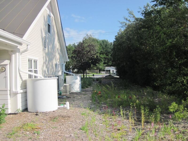 Photo contributed. A rain garden was built and rain barrels were added where the former driveway was.