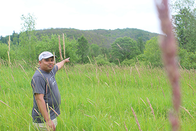 Photo by Scooter MacMillan Ko Gyi points out where he hopes to realize his dream of raising halal meat on the former Shirley Bruce Estate.