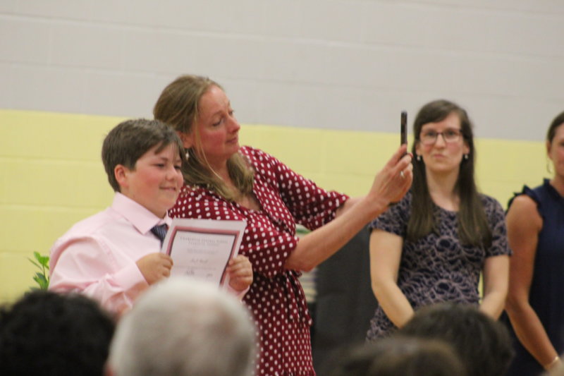 Photo by Scooter MacMillan. Charlotte Central School principal Jen Roth takes a selfie with graduating Levi Russell after handing him his diploma.