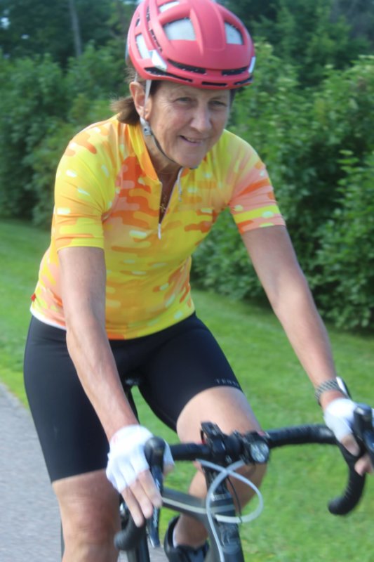 Photo by Scooter MacMillan. Liz Robert biking on Greenbush Road in Charlotte.