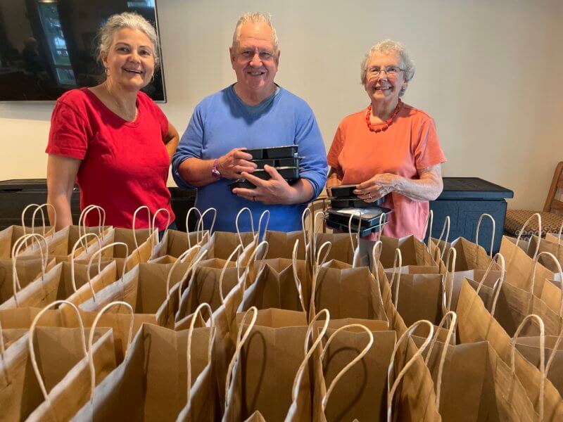 Photo by Lori York From left, Cheryl Sloan, Sean Moran and Roberta Whitmore help with Age Well Grab & Go meal distribution.