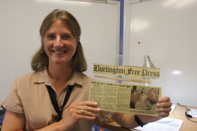 Photo by Scooter MacMillan.  Charlotte Central School’s new assistant principal Courtney Krahn holds a newspaper story about a trip she made to Montpelier with her class when she was a fifth grader at the school.