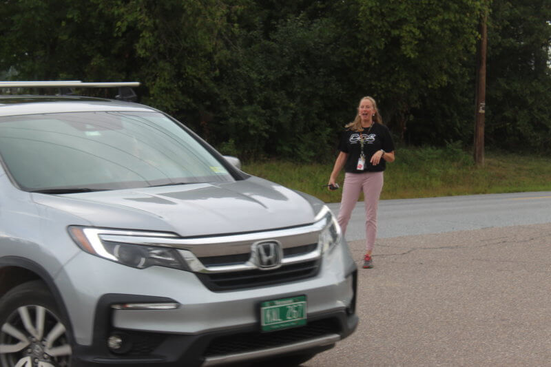 Charlotte Central School principal Jennifer Roth is all smiles as she directs traffic on the first day of school.