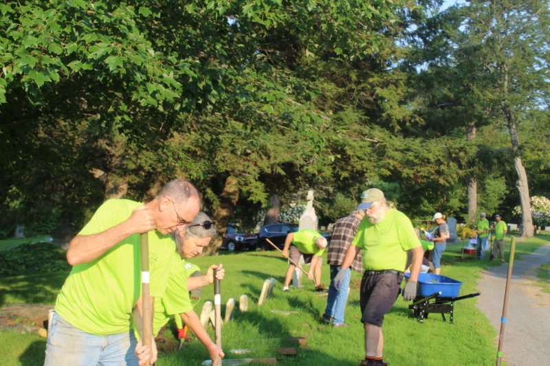 At right, Jim LaBerge works with a group of volunteers at Burlington’s Lakeview Cemetery in a section of destitute children’s graves from the late 1800s.