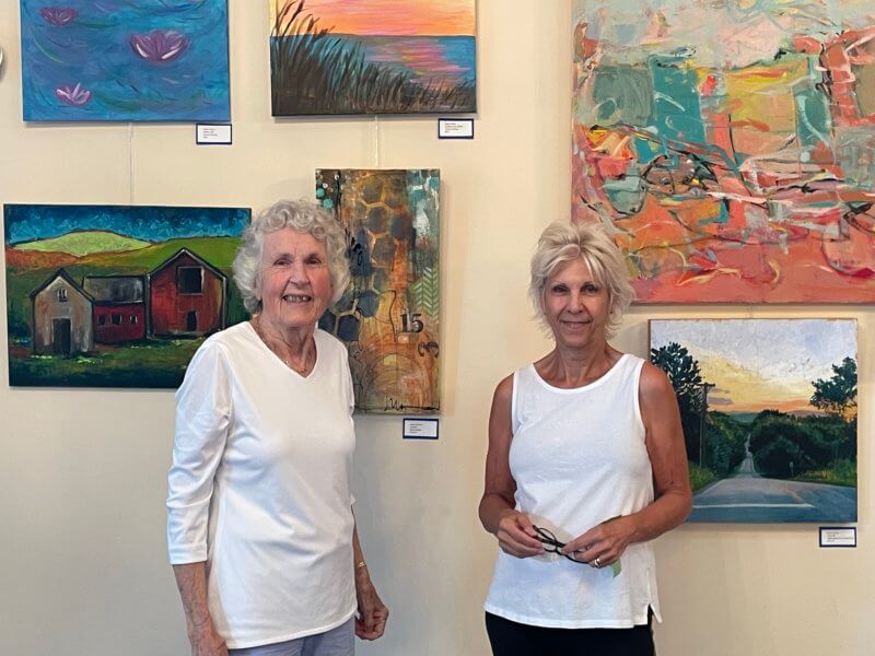Photo by Lori York From left, Judy Tuttle and Deb Peate setting up for the September senior art show at the Charlotte Senior Center, featuring work by local artists with a wide range of skill levels, age 50 and older.
