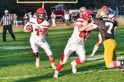 Photo by Al Frey Alex Provost blocks for quarterback Max Destito in Champlain Valley’s 28-21 victory over Essex on Saturday, Oct. 15.