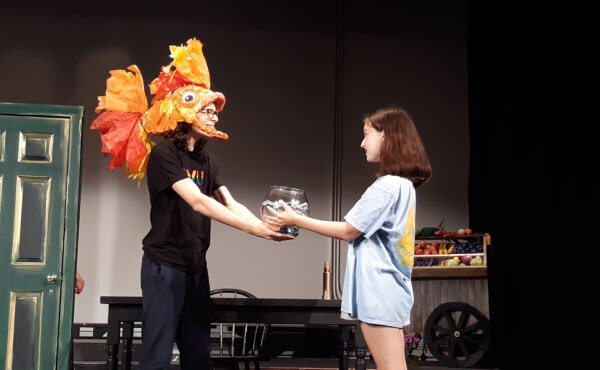 Vivian Volzer (young Amélie) and Addison Hoopes (Fluffy, her pet fish) rehearse a scene in CVU’s production of Amélie.