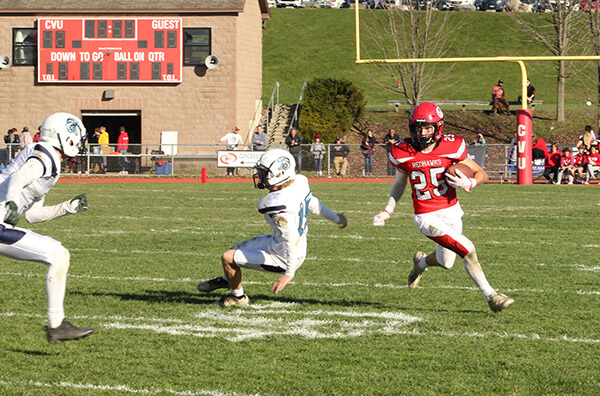 Photo by Scooter MacMillan Redhawk junior Calvin Steele makes one would-be tackler fall down as he runs with the ball.