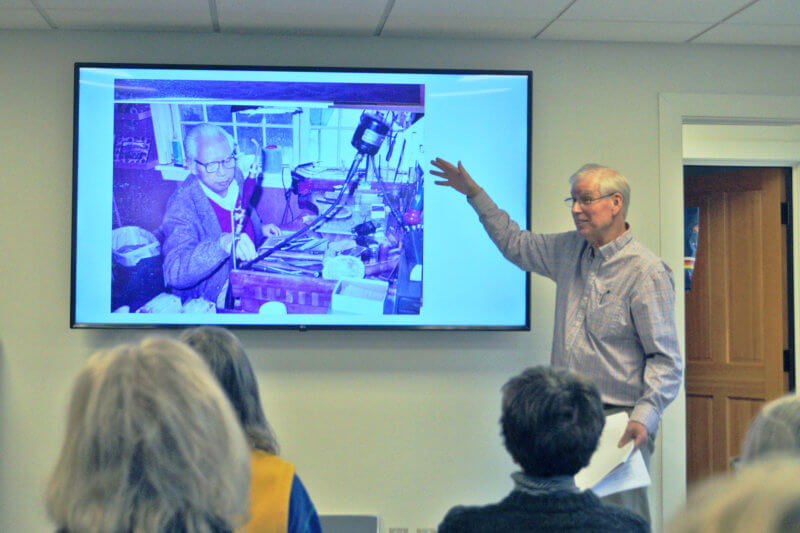 Photo by Juliann Phelps David Sisco shows a photo of Guy Cheng at his workbench. Sisco still uses the bench and some of his father’s tools today.