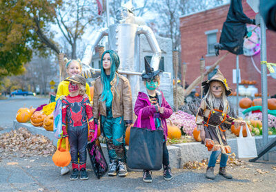 Children and their parents wear costumes at the annual Halloween party October 31, 2022 in Charlotte, Vermont. (Photo by Robert Nickelsberg/Getty Images)