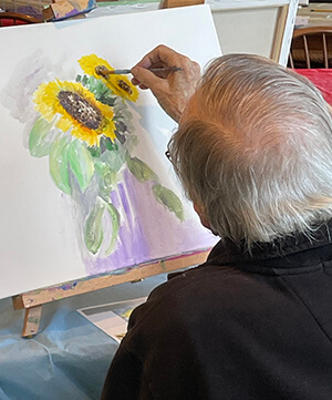 Photo by Lori York Frank Califano paints at a Coffee & Canvas sunflower workshop.