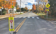 Photo by Brett Yates. Signs, including in the median, and painted crosswalks are strategies Shelburne has used to try to reduce speeding.