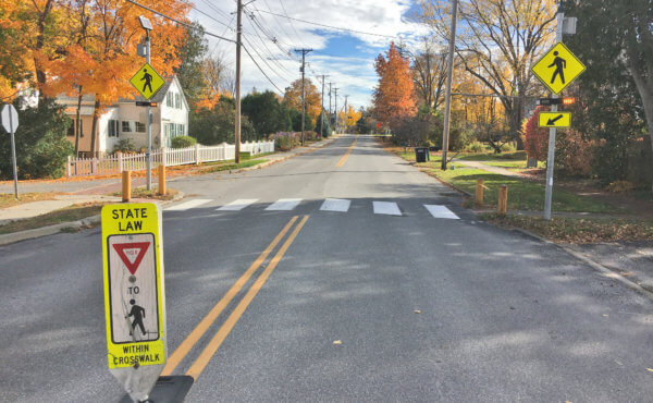Photo by Brett Yates. Signs, including in the median, and painted crosswalks are strategies Shelburne has used to try to reduce speeding.
