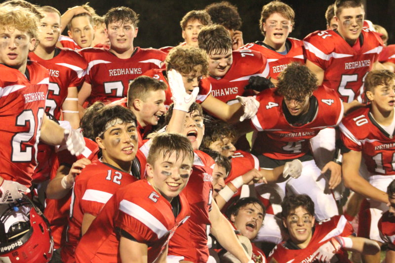 Photo by Scooter MacMillan. Players celebrate after the final seconds ticked down with the Redhawks holding on for a 24-19 win and the state championship.