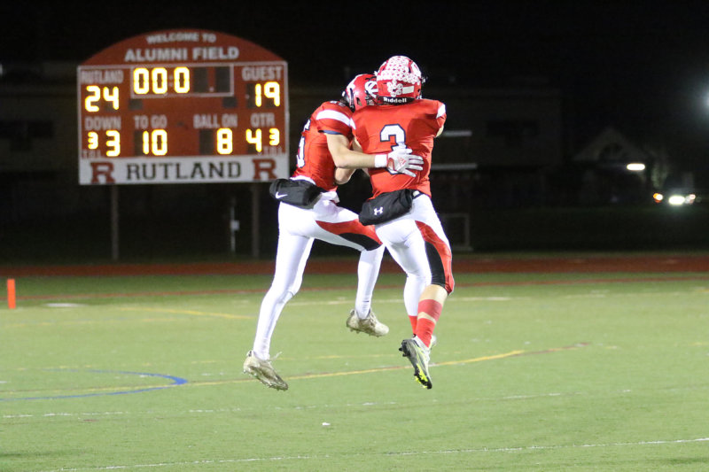 Photo by Paul Lamontagne/vtsportsimages.com From left, wide receivers and defensive backs Calvin Steele and Jack Sumner leap for joy with the scoreboard telling the story of CVU’s victory in Rutland on Saturday night.