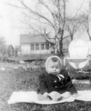 Photo courtesy Leo Roberts Above: Eight-month-old Gerald Roberts sits on the southside of the Mutton Hill School in May 1950. Route 7 is to the right.