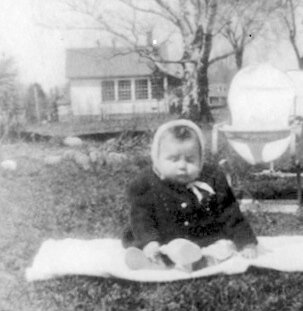 Photo courtesy Leo Roberts Above: Eight-month-old Gerald Roberts sits on the southside of the Mutton Hill School in May 1950. Route 7 is to the right.
