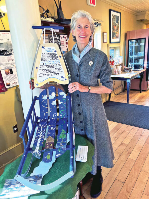 Photo by Lucie Lehmann Alexandra Lehmann with the sled she restored and painted to raffle off to raise funds for the Charlotte and Shelburne food pantries.