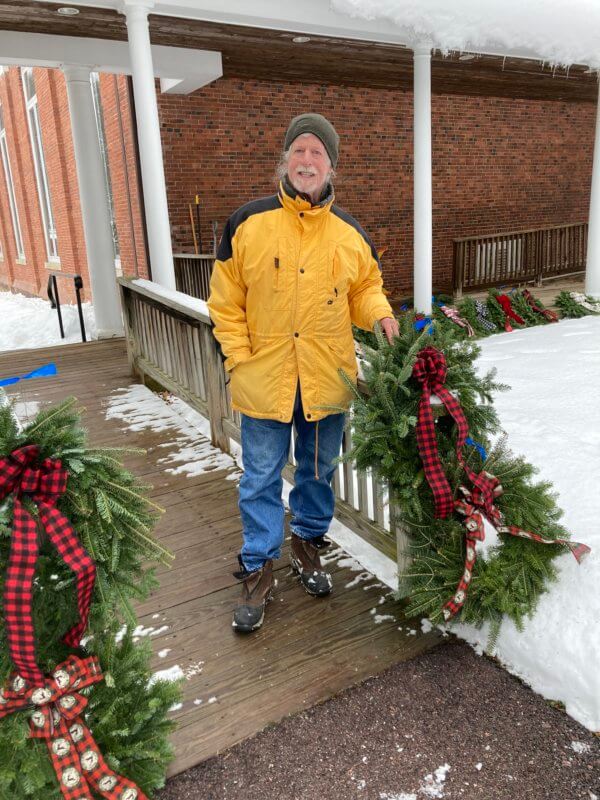 Photo by Karen DorisBill Doris handed out wreaths donated by Horsford Gardens and Nursery to people picking up food. Horsford has been donating wreaths to the food shelf during the holidays for 20 years.