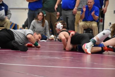Photo by Lisa Brace Camden Ayer tries to pin an opponent in the 120-pound weight division at the Champion Commodore Invitational in Vergennes.