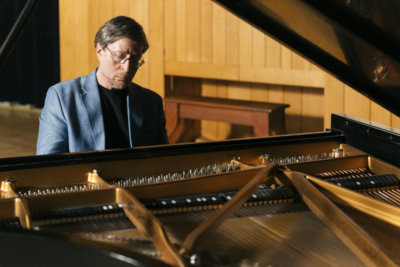 Pianist David Feurzeig will perform in Charlotte on Feb. 12 for the 24th concert in his Play Every Town tour, visiting all 252 towns in Vermont to combat climate change by demonstrating a way to perform that doesn’t require flying all over.