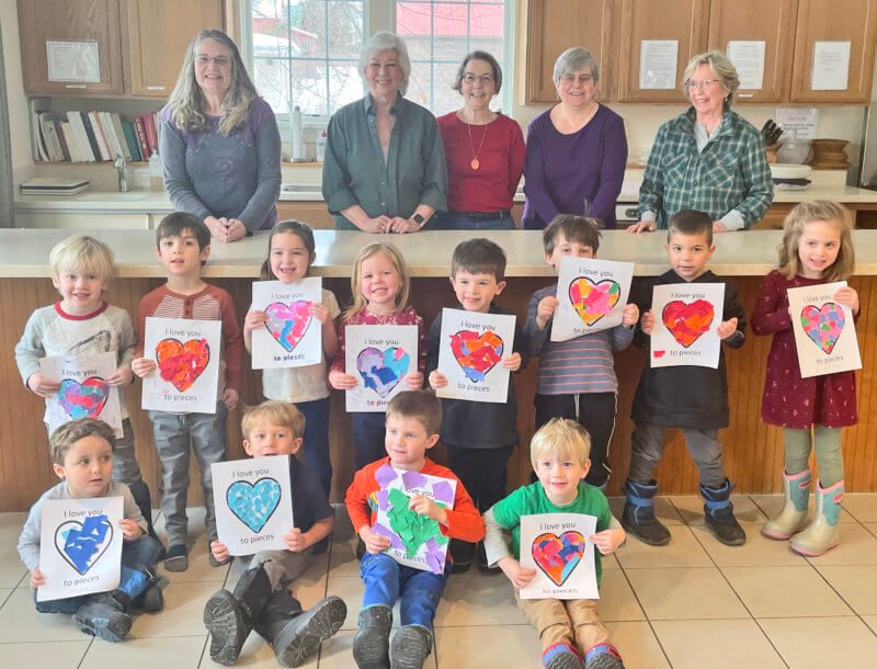 Photo by Lori York Valentine craft activity with Charlotte Senior Center volunteers and preschool children from Charlotte Children’s Center.