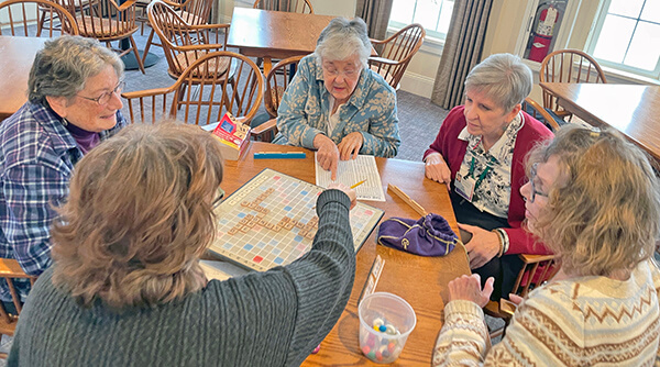 Photo by Lori York From left, Cyndie White, Kathy Ayers, Lin Kalson, Penny Burman and Diane Boucher play word games at the senior center. These Wednesday sessions feature a variety of games including Scrabble, Boggle and Bananagrams.  