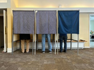 Photo by Alicia Wolfram Three people from Charlotte standing up for democracy in the ballot booth.