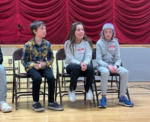 Photo by Genevieve TronoFrom left, fourth graders Eddie Moore, Anna Andriano and Matilda McCracken hung on until six spellers remained.
