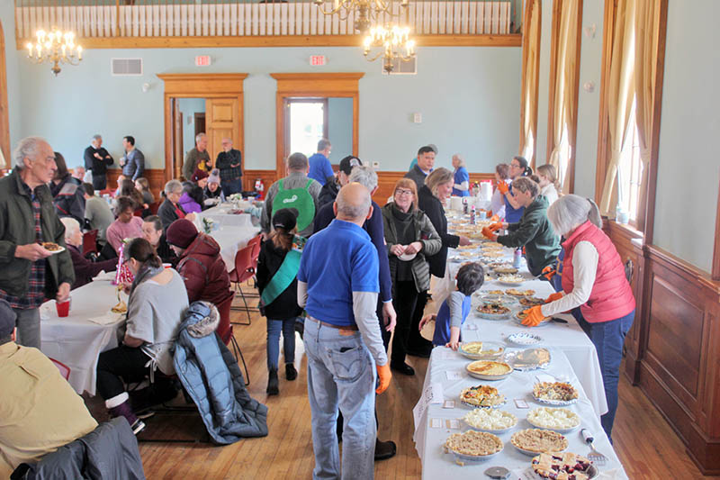 The Shelburne Town Hall filled with pies and pie eaters.